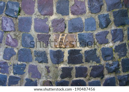 Carved letters in grey paving stones