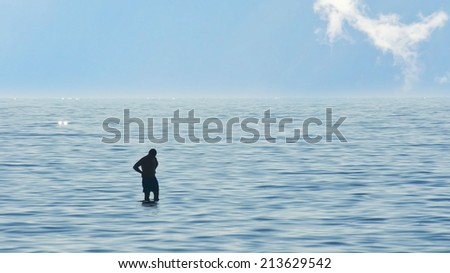Man contemplating surrounded by water, silhouette of a man in the middle of the sea. Concept for contemplation