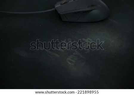 I hate my job, written on used mouse pad and a mouse in the background. Concept for I hate my job
