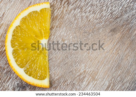 Organic orange fruit. Slice of orange on wooden background