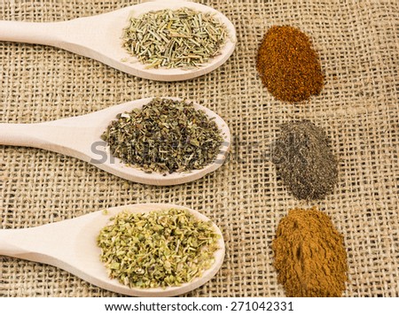 Various herbs and spices on burlap texture. Organic food concept.