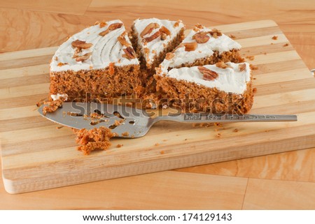 Slices of carrot cake on a wooden cutting board