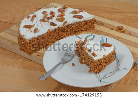 Slice of carrot cake on a desert plate with cake fork