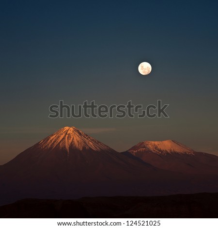 Full-moon in the Moon Valley. Volcanoes Licancabur and Juriques, west of San Pedro de Atacama, Chile in the Cordillera de la Sal, in the Atacama desert of Chile