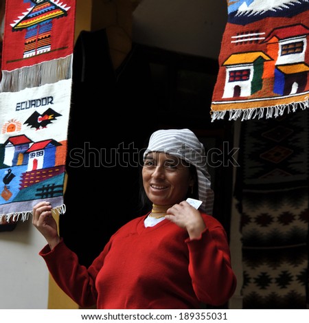BANOS, ECUADOR - JUNE 23, 2010: Indian women in national clothes sells the products of her weaving, as usual on weekdays on the market, on June 23, 2010 in Banos de Agua Santa, Ecuador