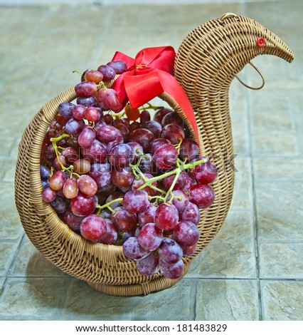 a lovely bird shape basket full of grapes
