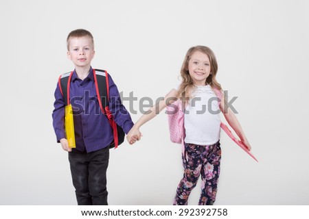 Elementary school pupils boy and girl go to school