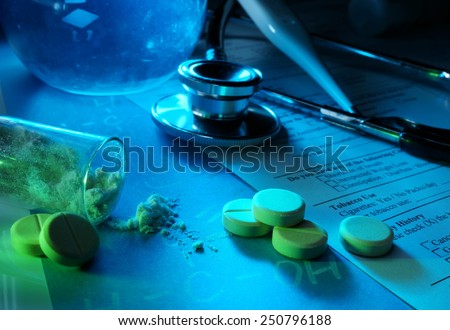 Medicine concept. Tablets, Syringe, stethoscope and powder on medical billing statement. Selective focus.