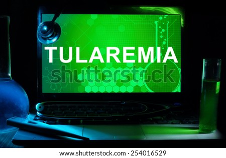 Computer with word Tularemia. Test tubes, stethoscope and thermometer.