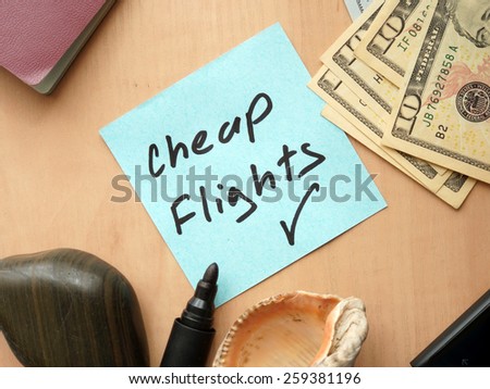 Cheap Flights paper on a table with money