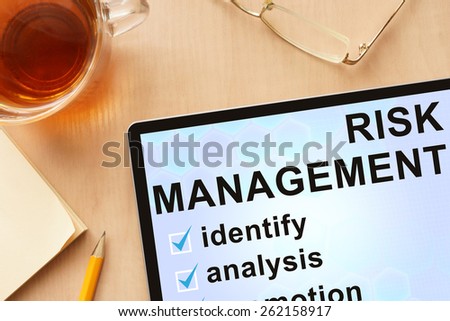 Tablet with words  risk management . Business concept.