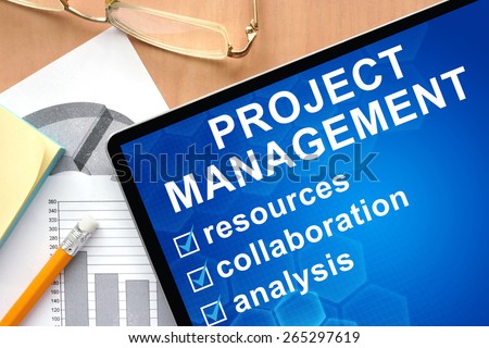 Tablet with words project management . Business and management concept.