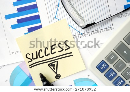 Papers with graphs, calculator and  Business success concept.