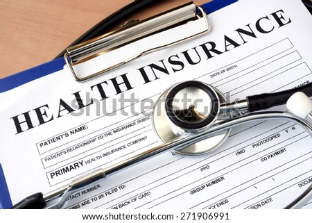 Health insurance form with stethoscope.
