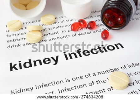 Paper with kidney infection and pills. Medical concept.