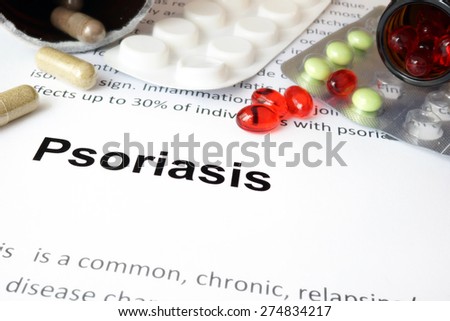 Paper with psoriasis treatment and pills. Medical concept.
