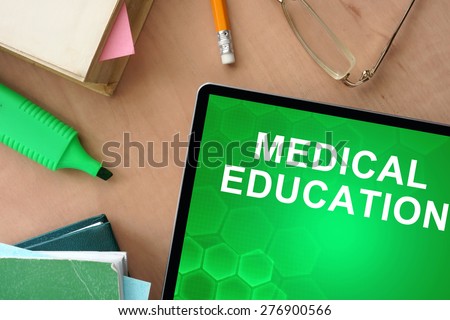 Books and tablet with words Medical Education