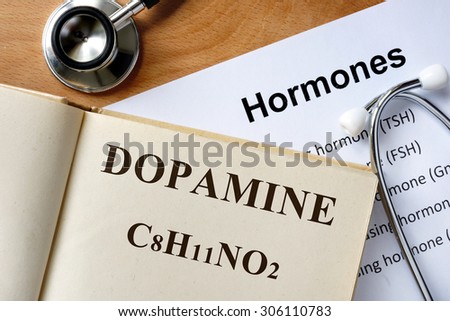 Dopamine  word written on the book and hormones list.