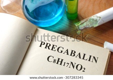 Book with Pregabalin and test tubes.