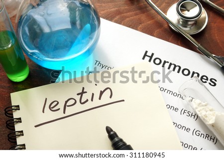 Hormone leptin written on notebook. Test tubes and hormones list.