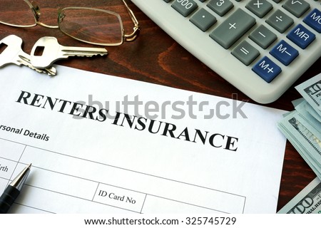 Renters insurance  form and dollars on the table.