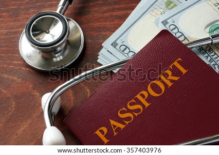 Medical tourism concept. Stethoscope with passport and dollar bills.