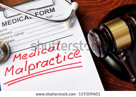 Medical form with words Medical Malpractice and gavel.