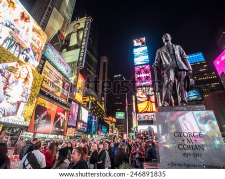New York - Circa OCT 2014: Statue of famed showman George M. Cohan and huge outdoor billboards promoting Broadway musicals in Times Square