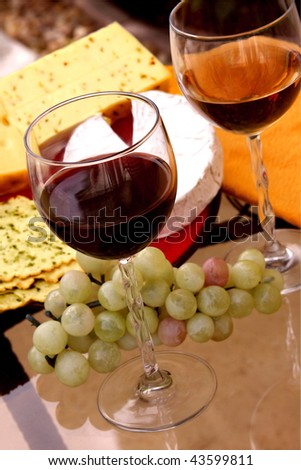 Different types of cheese and grapes and wine
