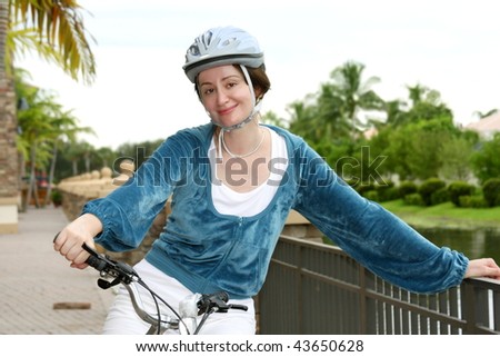 Young woman in helmet biking in the city
