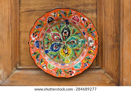 painted plates on the background of wooden furniture