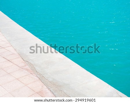 turquoise sea and a concrete pier