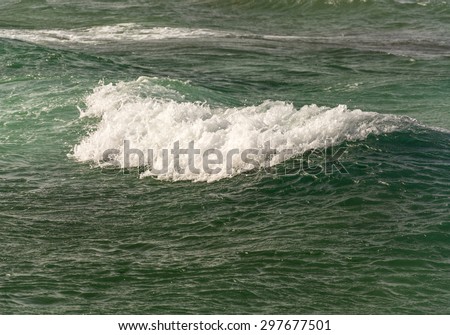 waves and foam on the turquoise, clear and clean sea