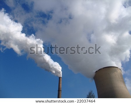 Steam geting out of a cooling tower of a coal power plant into blue sky