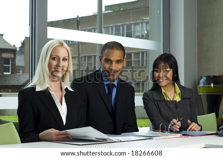 Business meeting in a modern office with everyone smiling