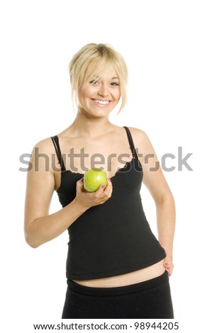Pretty blonde woman holding a green apple smiling isolated on a white background