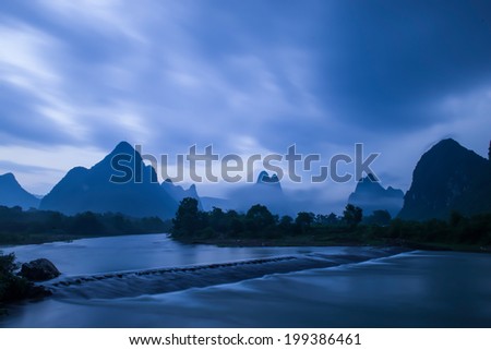 After the storm, the river mountains wreathed in mist