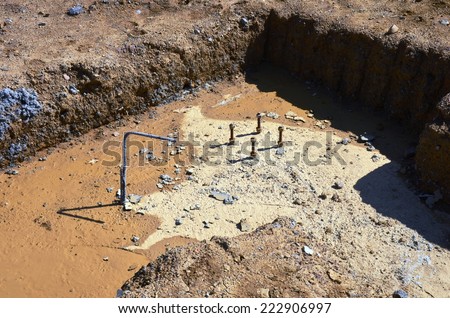 Concrete foundations with reinforcing bars and mud