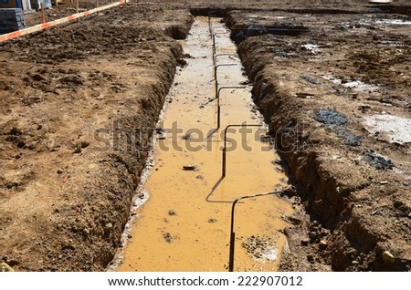 Concrete foundations with reinforcing bars and mud