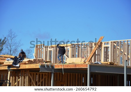 Wood building framing with steel columns and steel beams