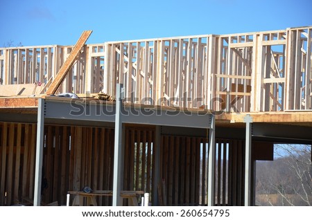 Wood building framing with steel columns and steel beams