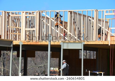 Wood building framing with steel columns and steel beams
