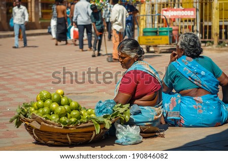 MADURAI/INDIA - DEC 23. Woman sells fruit on a city street on December 23, 2013 in Madurai, Tamil Nadu, India. Madurai known as a city where located one of the most famous Hindu Meenakshi Amman Temple