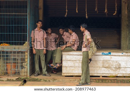 KERALA, SOUTH INDIA - NOV 20: Indian students boys waiting for a school bus in Varkala, Kerala, India