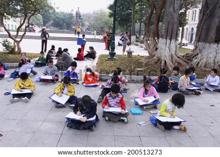 Hanoi, Vietnam February 26: Unidentified school children learn to draw outdoor at park on February 26, 2011 in Hanoi, Vietnam