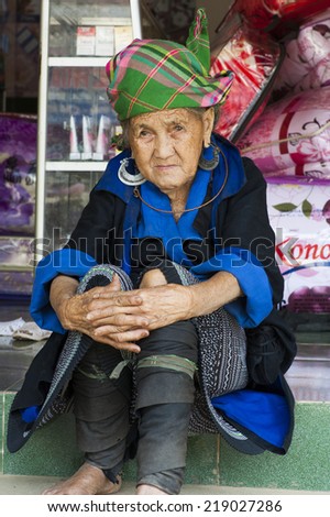 Yen Bai, Vietnam - Sept 22, 2012: Portrait of Hmong old woman sitting on Nga Ba Kim market. The Hmong are an Asian ethnic group from the mountainous regions of China, Vietnam, Laos, and Thailand