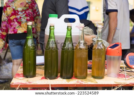 Bottles of bee\'s honey displayed for selling in mountainous road of Vietnam