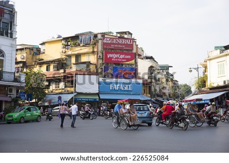 Hanoi, Vietnam - Oct 26, 2014: A Corner of Hanoi with bunch of logo and brand name on Hang Dao st, near Hoan Kiem Lake, Center of Hanoi. Vehicles running on a busy street.