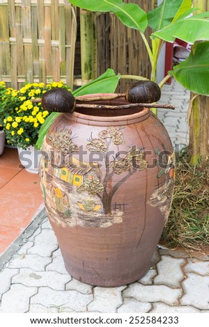 Asian old traditional clay water jar, coconut fruit water ladle, the things seen in rural countryside region