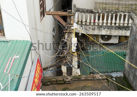 Hanoi, Vietnam - Mar 15, 2015: Electric wires cross houses in Hanoi, Vietnam. Large collections of electric wires are a common site in Hanoi.